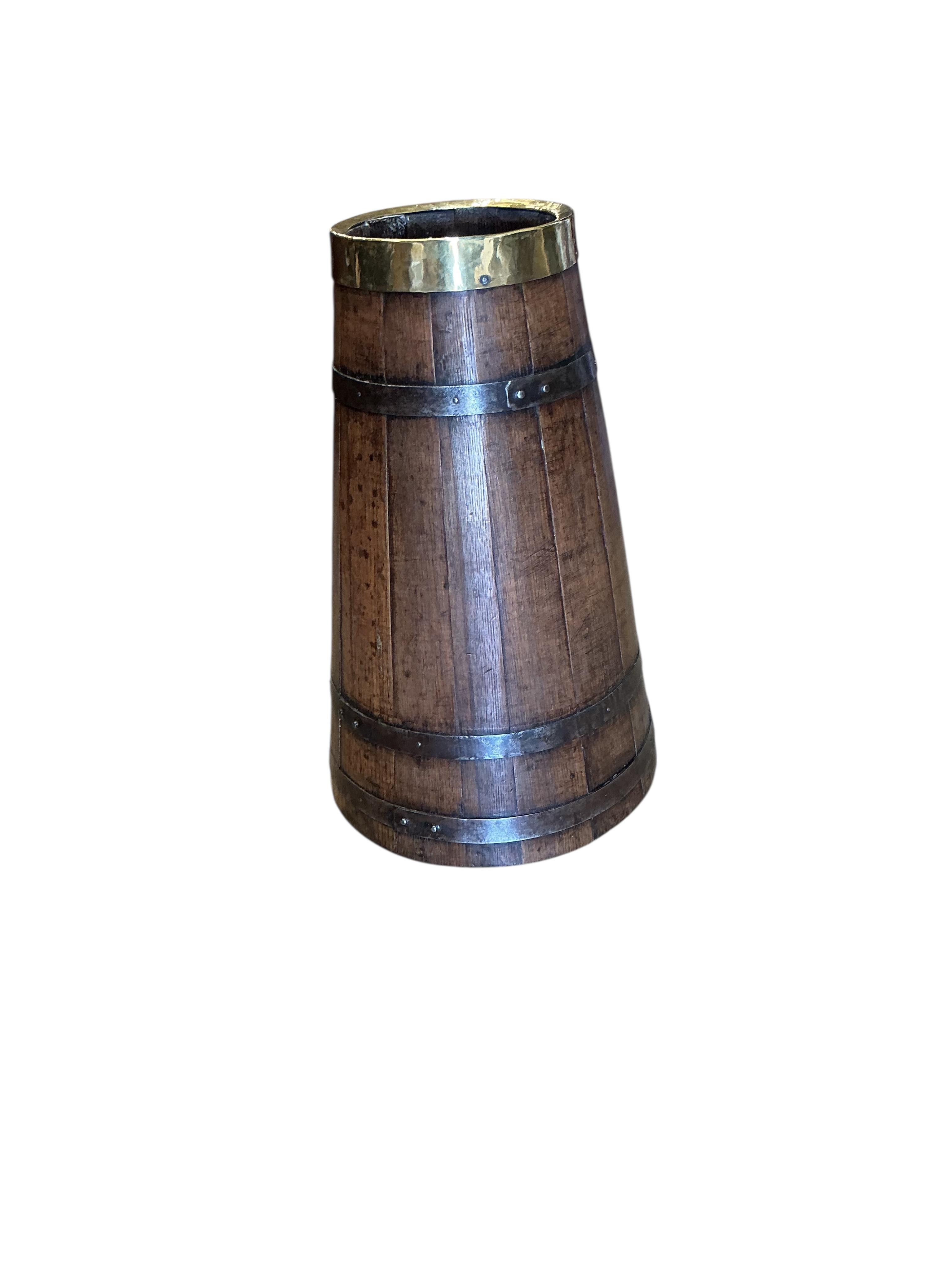 An Arts and Crafts brass and iron bound staved oak circular stick stand, height 55cm
